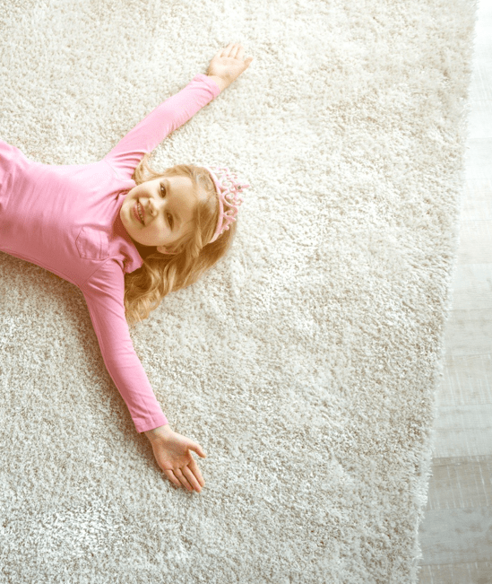 Cute girl laying on rug | Rugs Rolls and More